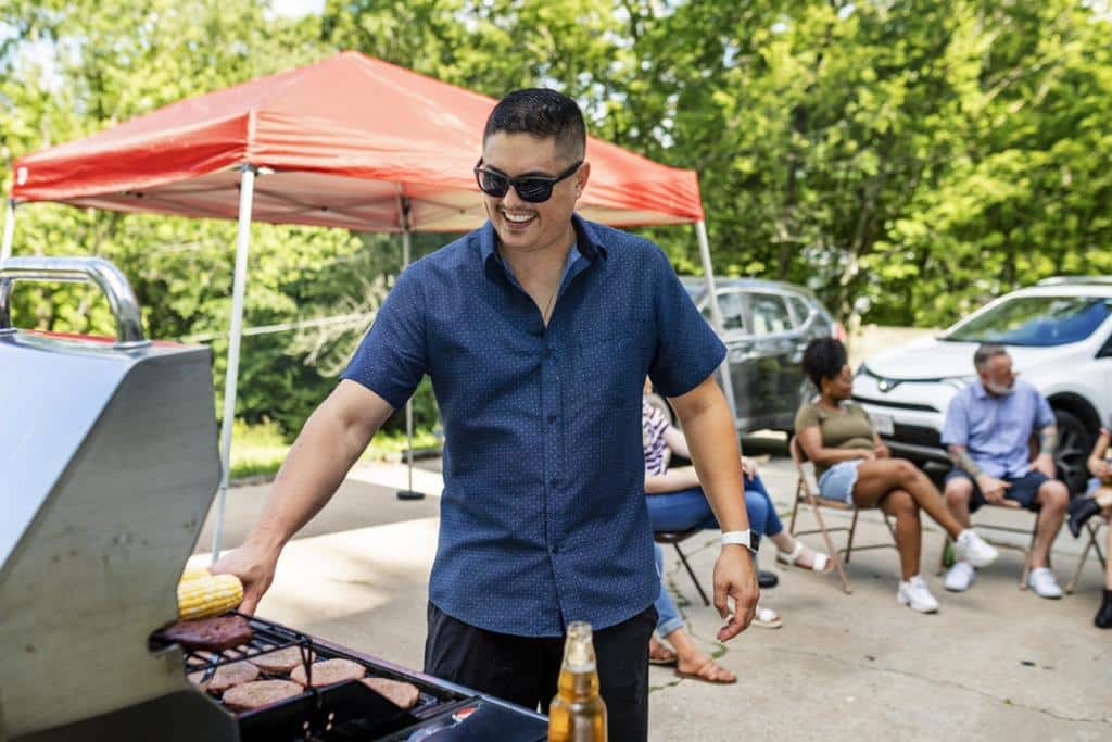 man at BBQ cooking when colour blind makes it hard to check if meat is done